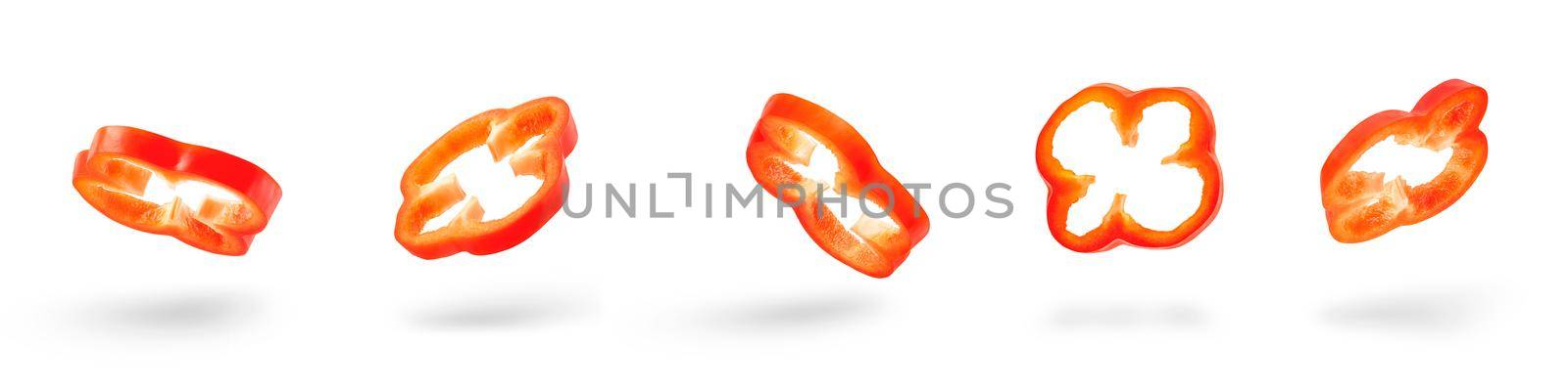 Set of slices of red pepper drops on a white background. Paprika flying in air on isolated white background by SERSOL