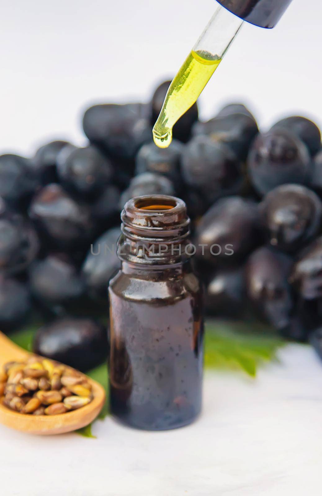 Grape seed oil in a small bottle. Selective focus. nature.