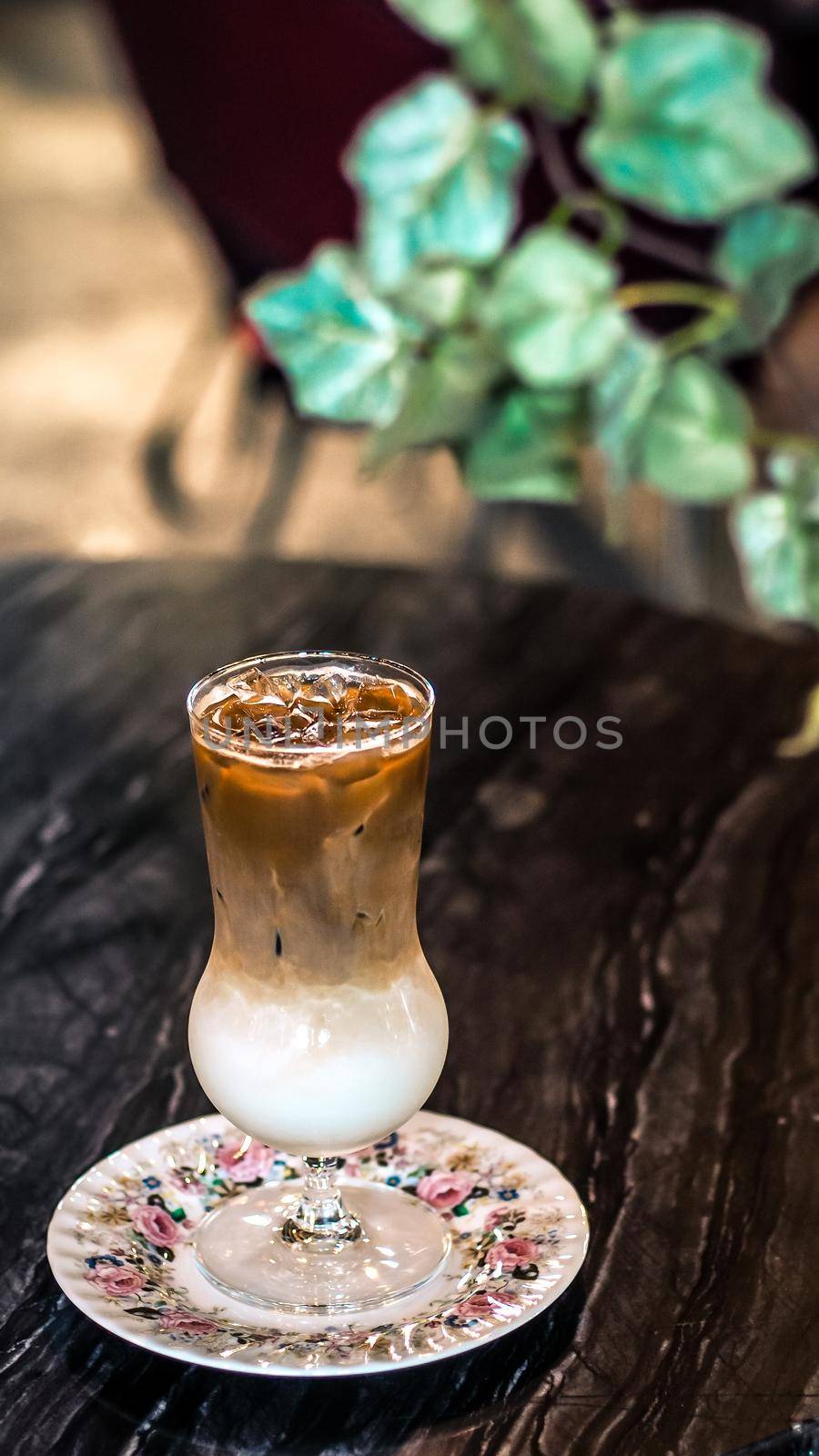 Chocolate frappe on wooden table background of Restaurant with vintage style interior