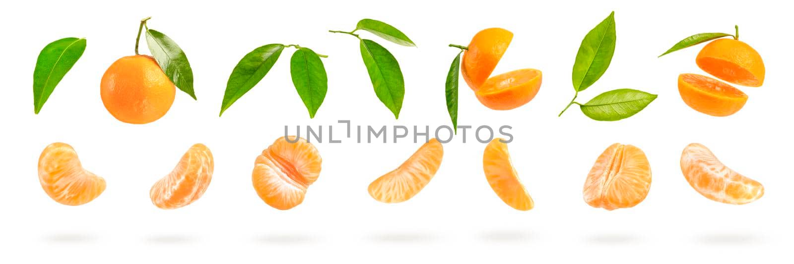 Big set of tangerine parts, different tangerine segments isolated on white background. Leaves and pieces of tangerine fall, casting a shadow.