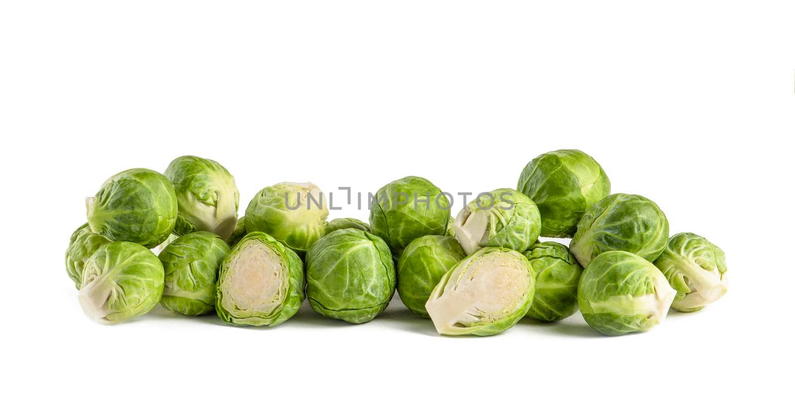 Brussels sprouts, isolate. Fresh, small Brussels sprouts stacked in a stack on a white isolated background. by SERSOL