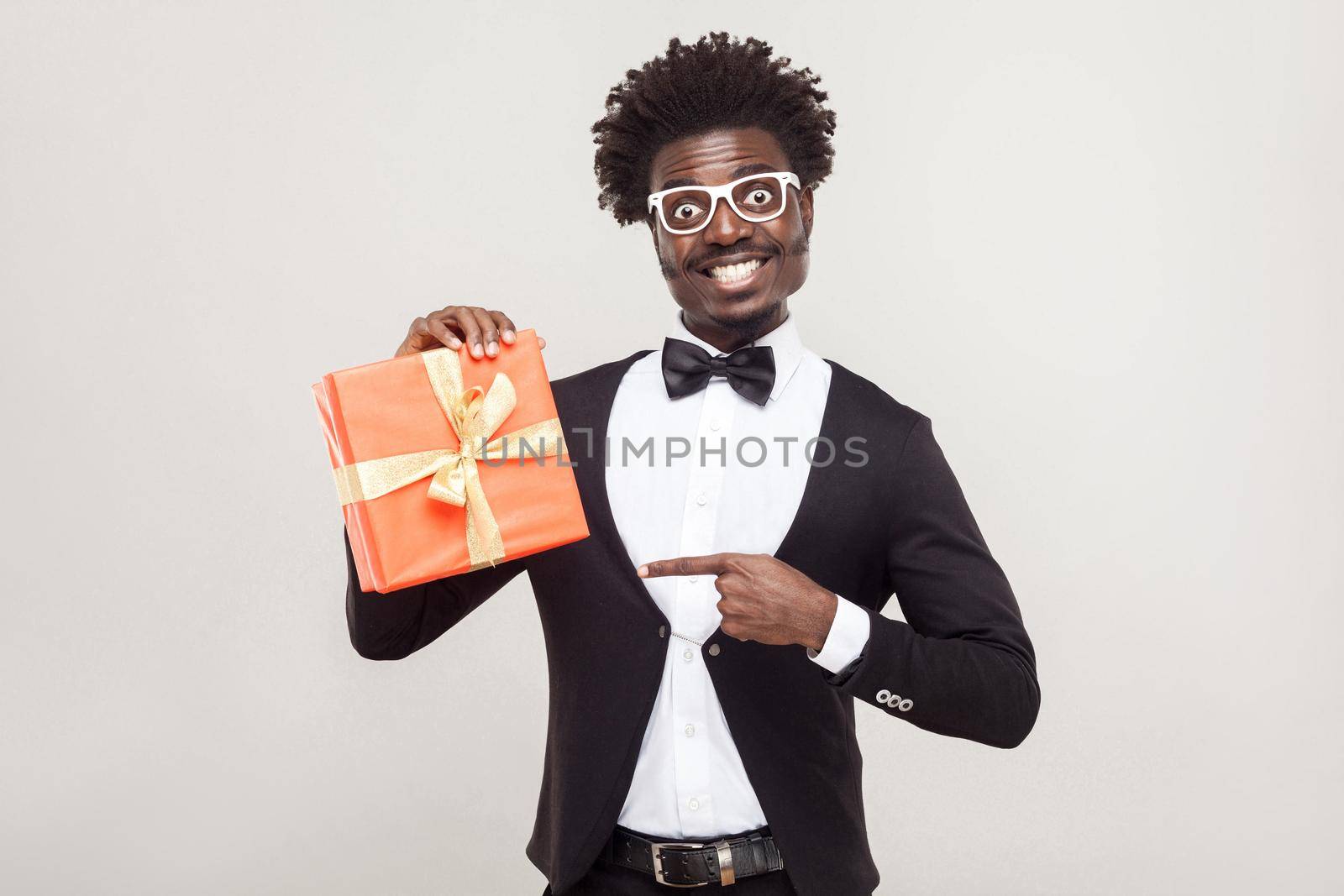 African businessman pointing fingers at gift box. by Khosro1