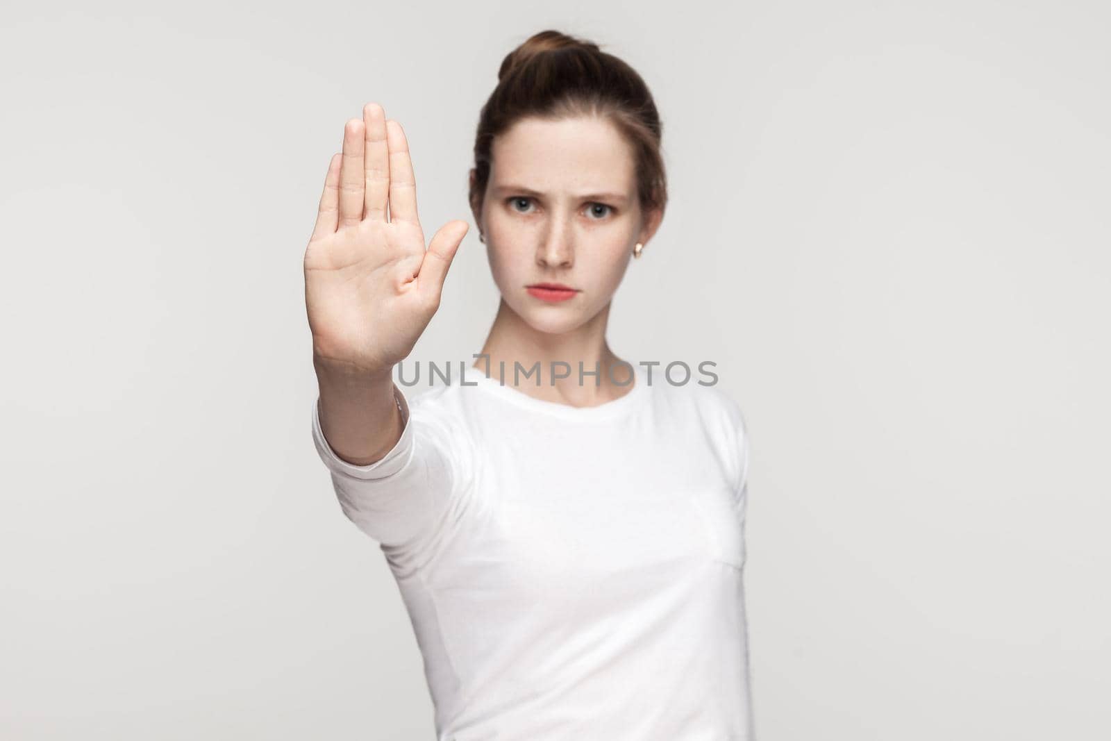 Stop sign. Focus on hand. Body language. Gray background