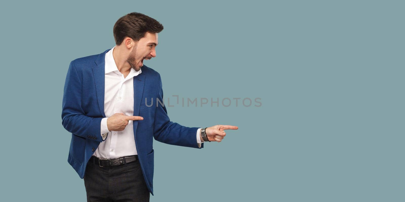 man standing and pointing at background and screaming and looking at copy space. by Khosro1