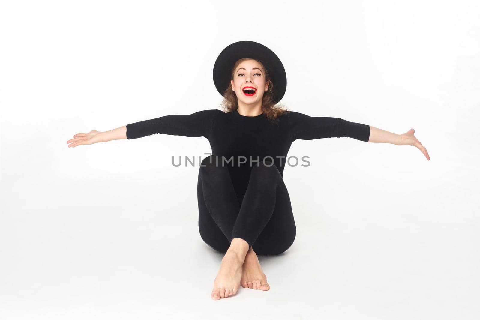 Happiness beautiful woman in hat, sitting on floor. by Khosro1