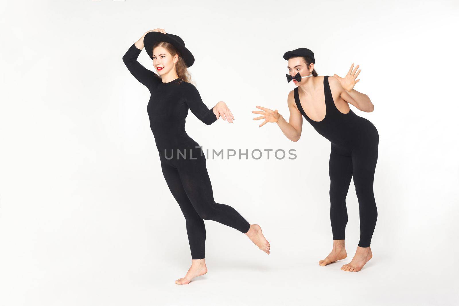 Two circus mimes clown showing sketch about love. Studio shot, isolated on white background