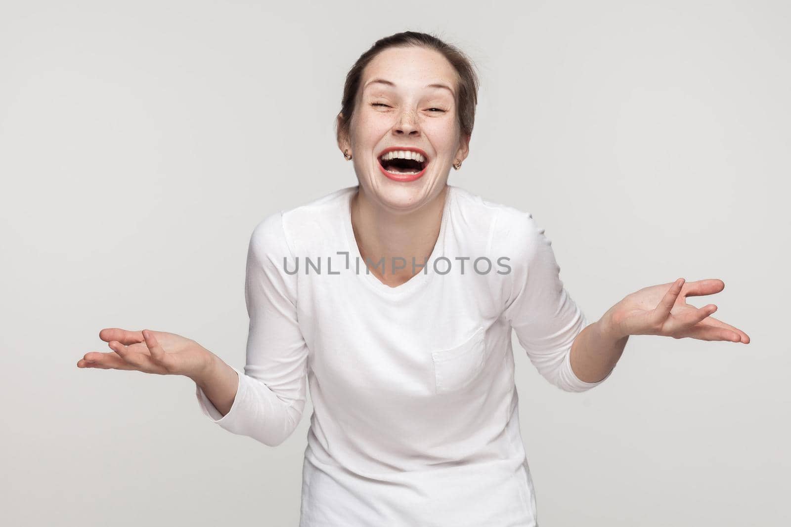 Happiness concept, laugh. Optimistic girl toothy smiling. Studio shot