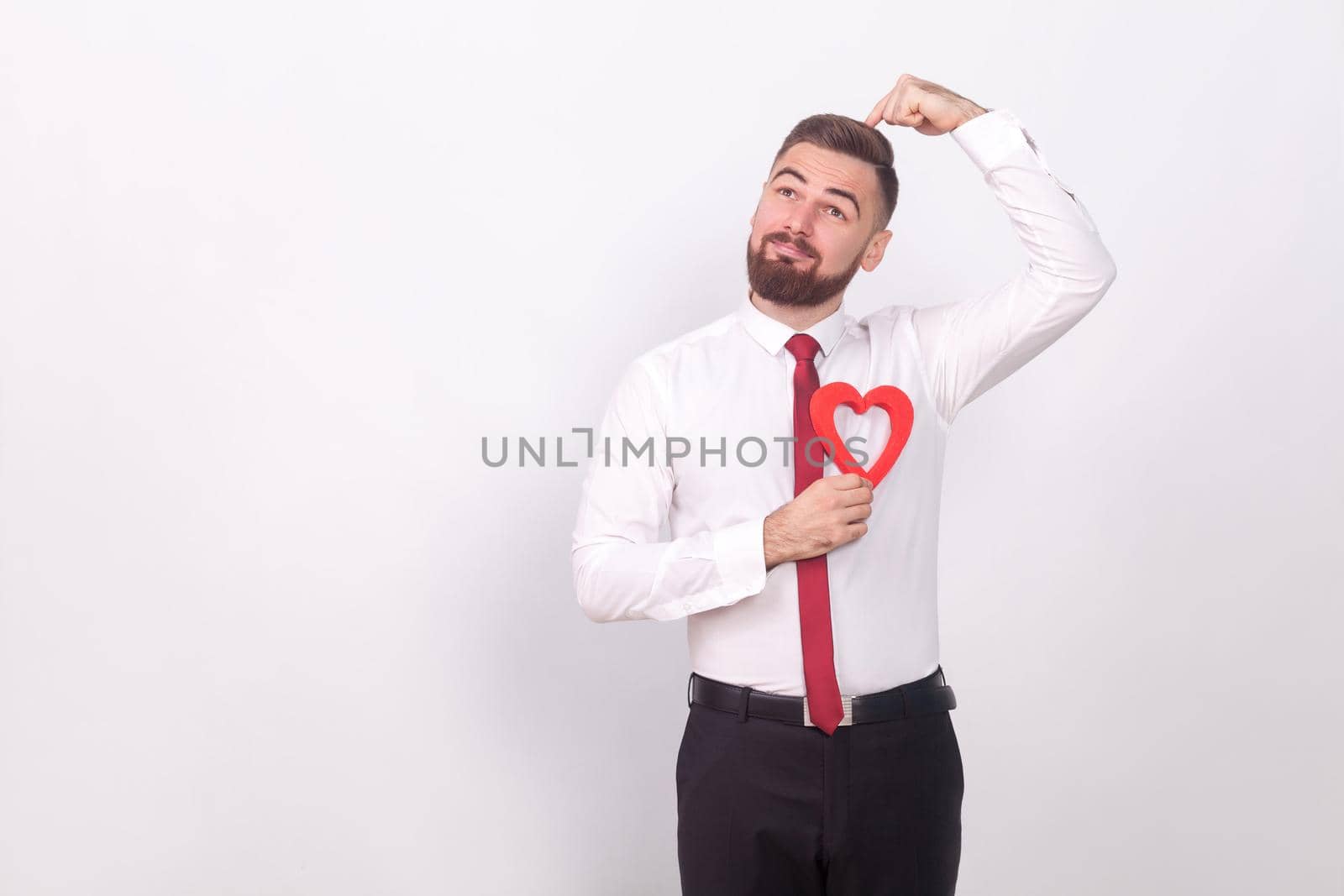 Great idea! Man find his love. Indoor, studio shot, isolated on gray background