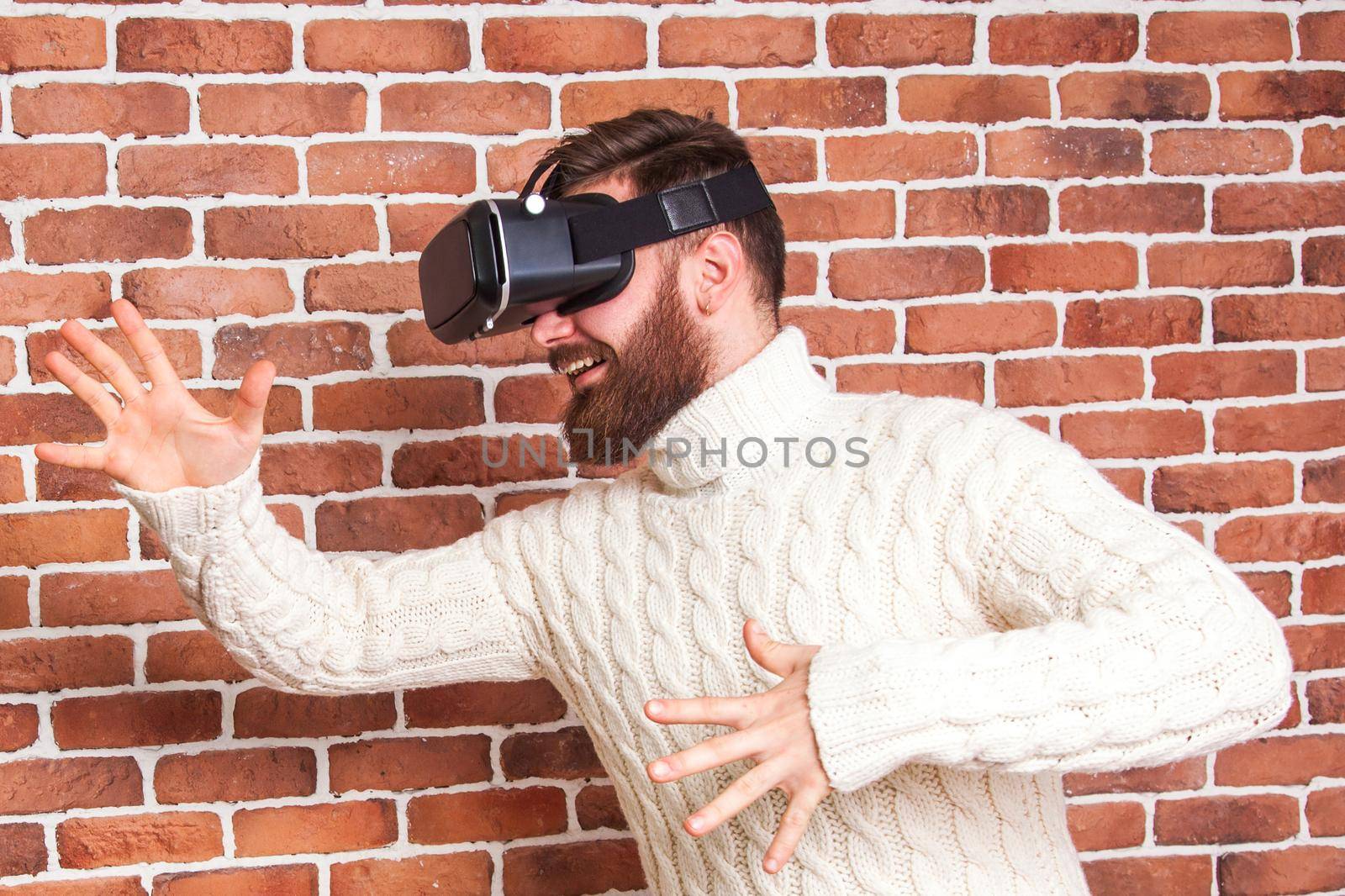 loneliness and illusion of new year. the portrait of bearded man with virtual reality glasses near new year's tree.