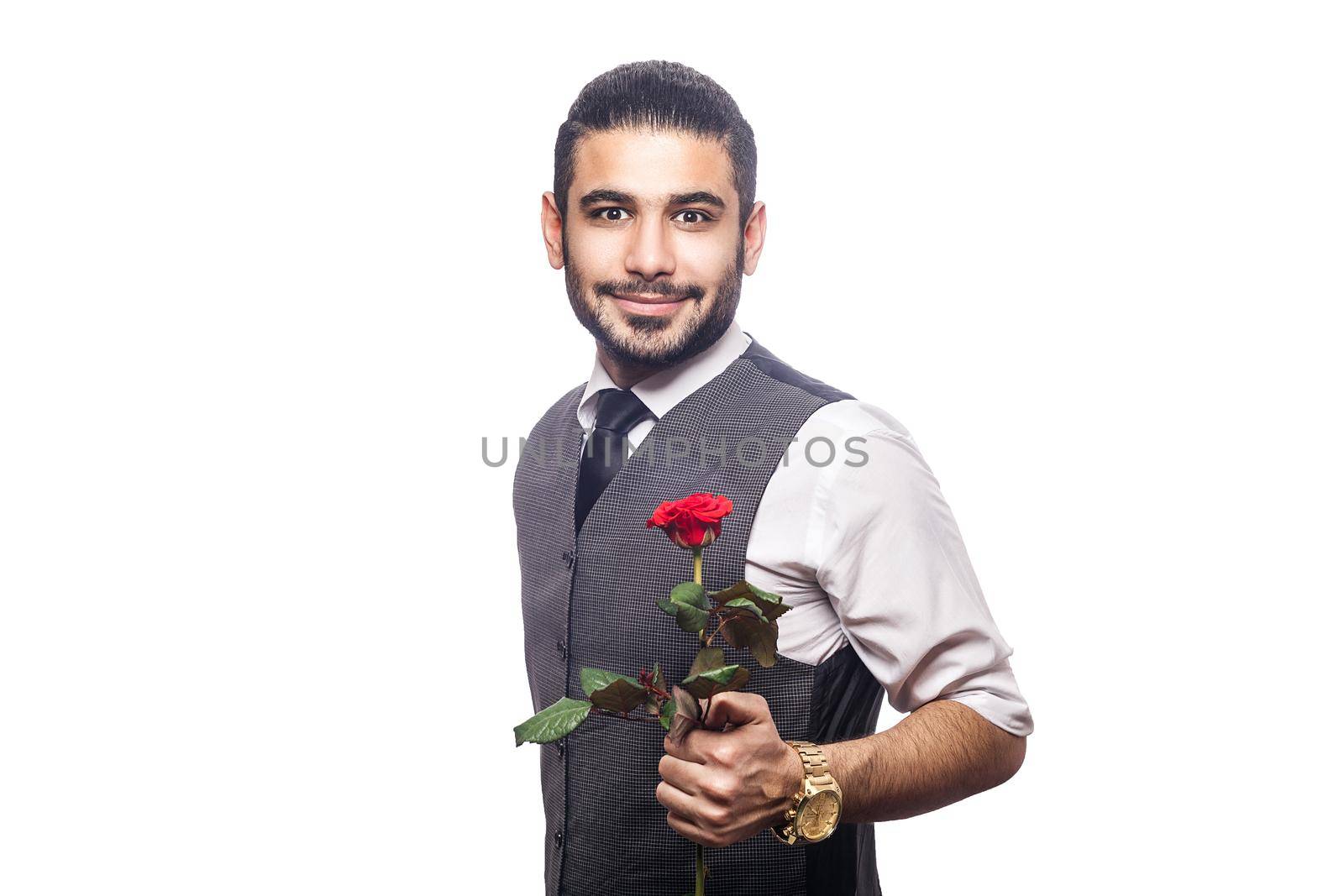 Handsome romantic happy man with rose flower. studio shot. isolated on white background. holding and giving flower and looking at camera and smiling..