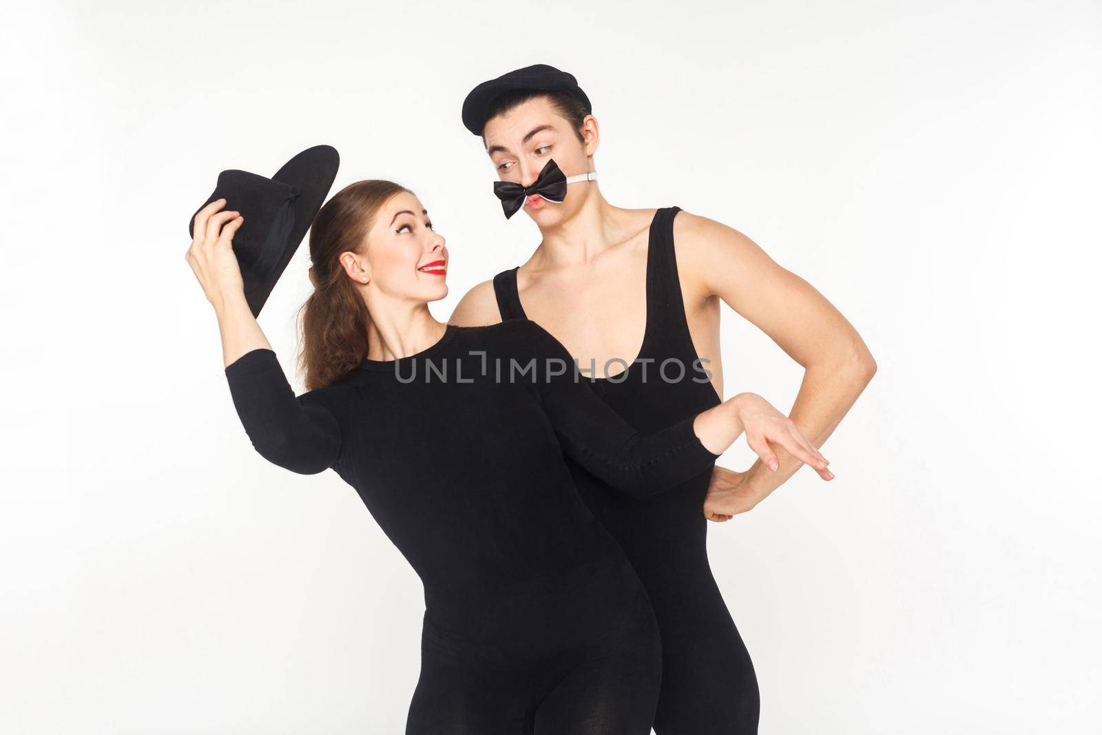 Comedy, humor. Two comedian mimes showing sketch about love. Studio shot, isolated on white background