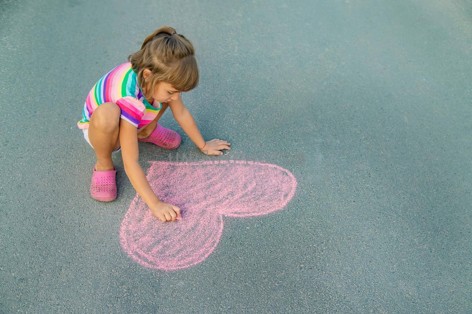 Children's drawings on the asphalt with chalk. Selective focus. by yanadjana