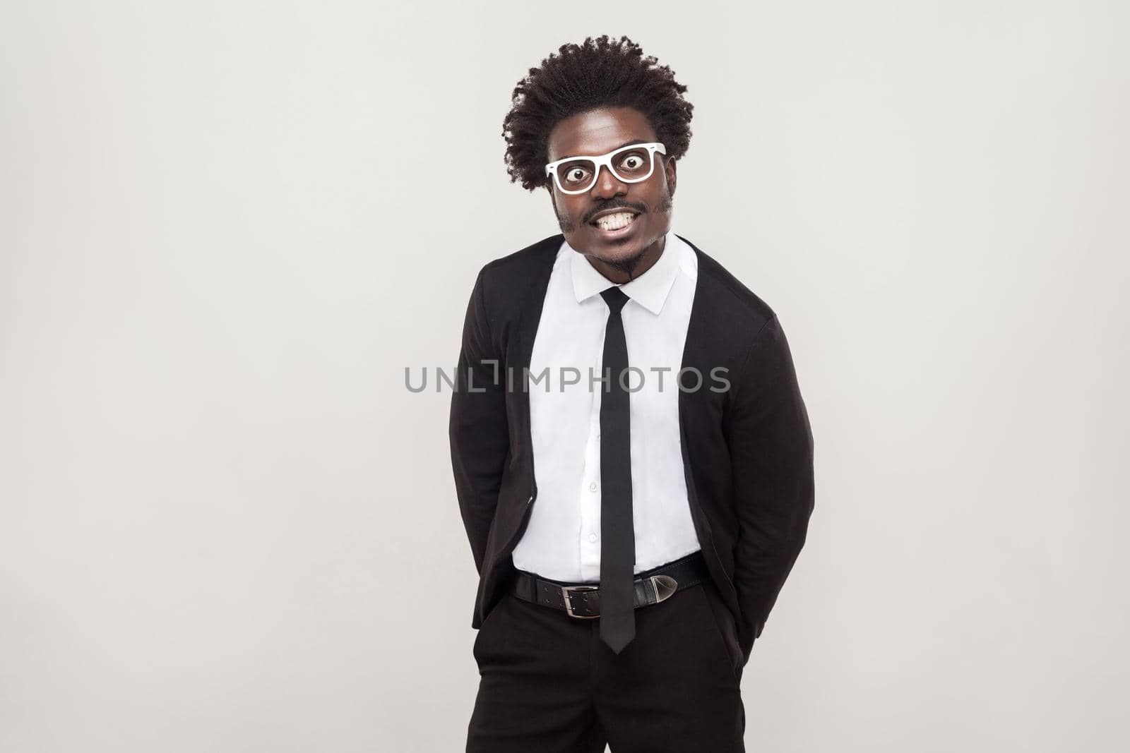 Idiotic afro man in white glasses grimacing at camera. by Khosro1