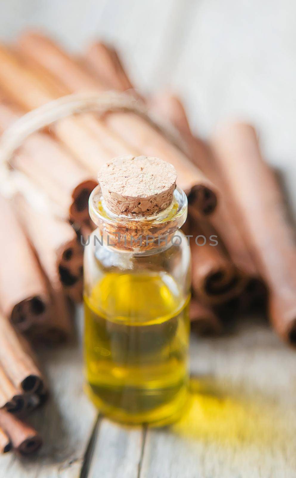 Cinnamon essential oil in a small bottle. Selective focus. nature.