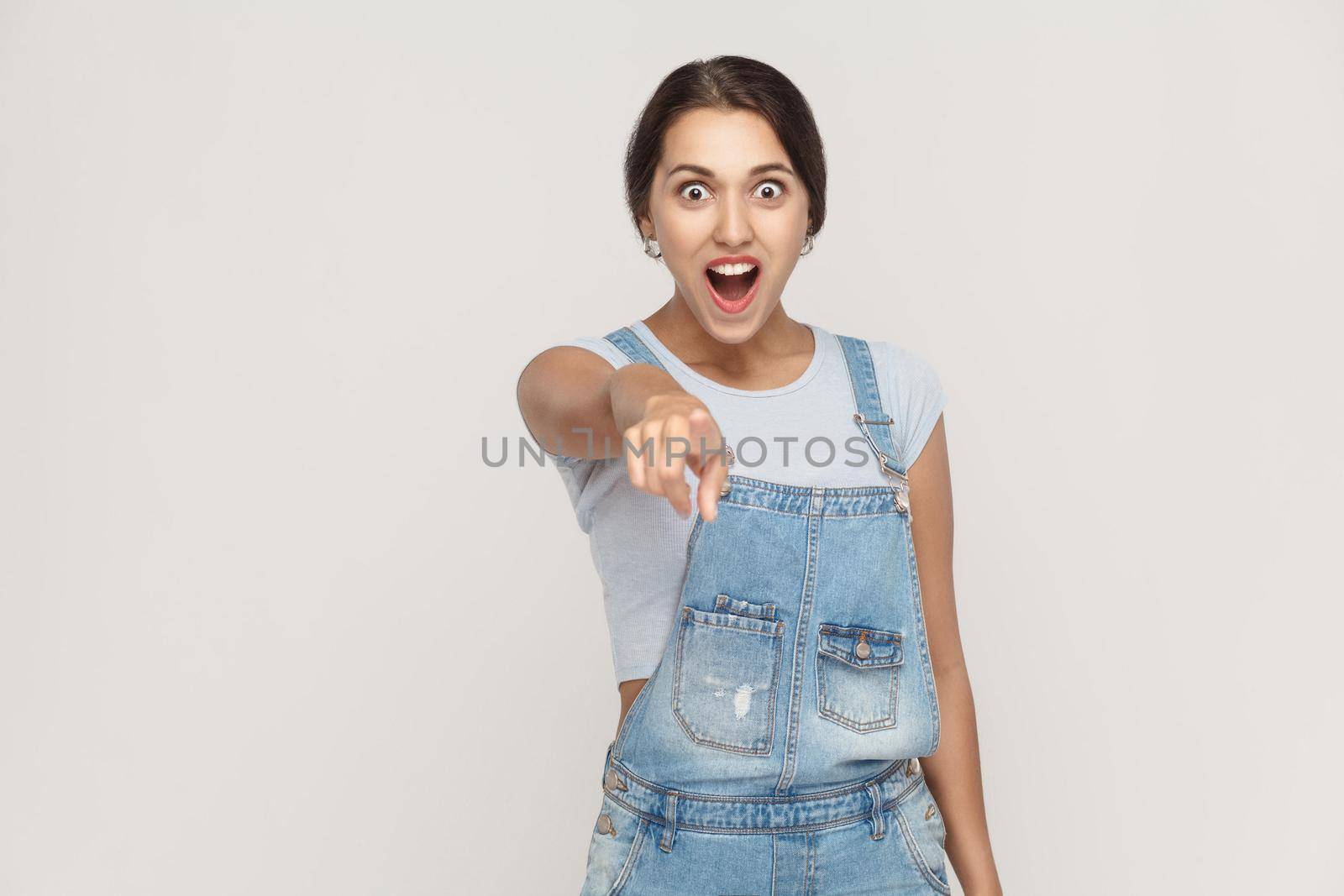 Wow that's great! Portrait of young adult caucasian woman with shocked facial expression. Indoor, studio shot