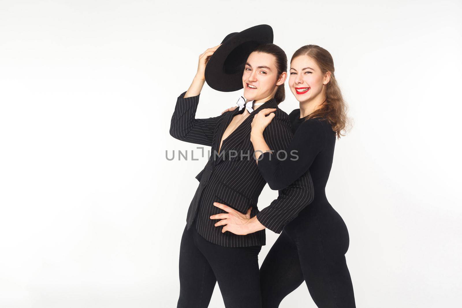 Beautiful woman embrace proud man , looking at camera. Studio shot, isolated on white background