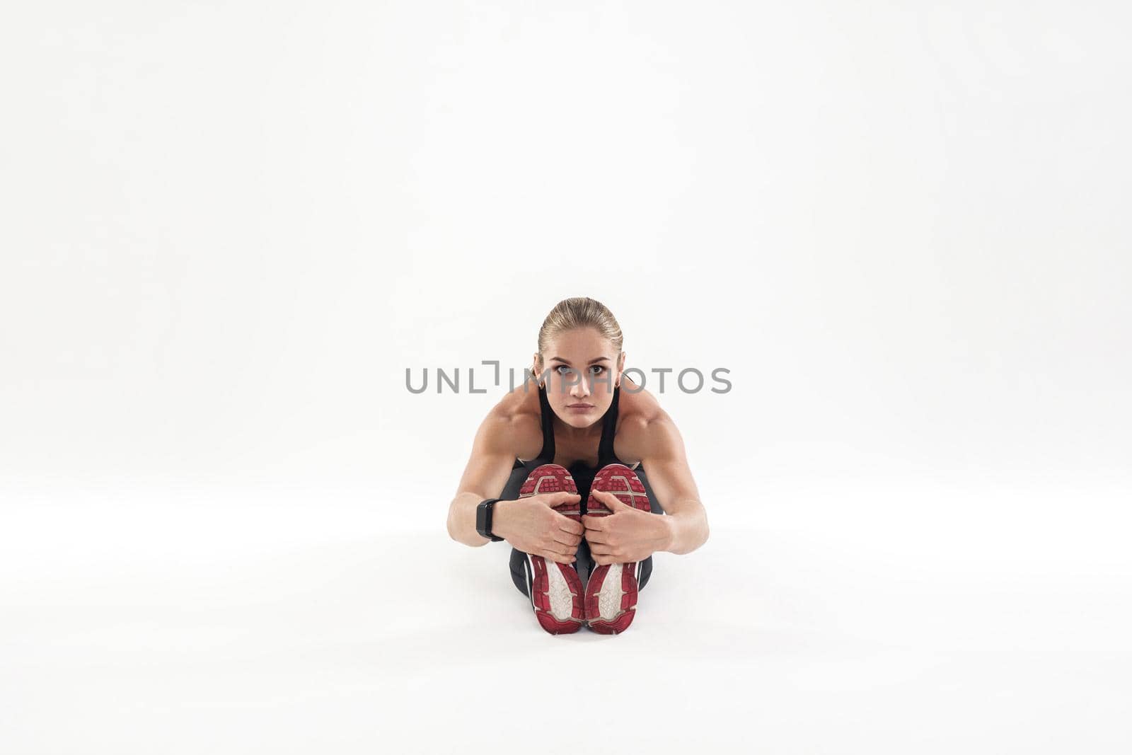 Fitness woman doing at the work-out morning, tilt forward. Studio shot