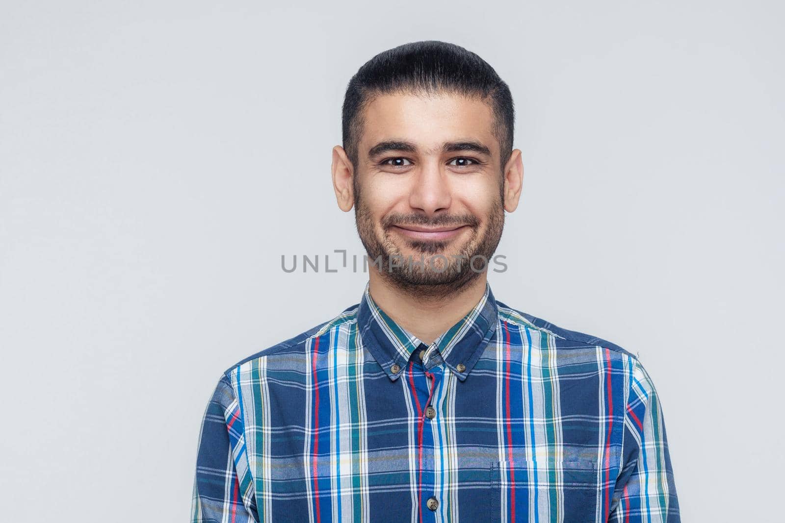 Happiness bearded businessman smiling into camera. Businessman with beard grinning having positive look. Studio shot