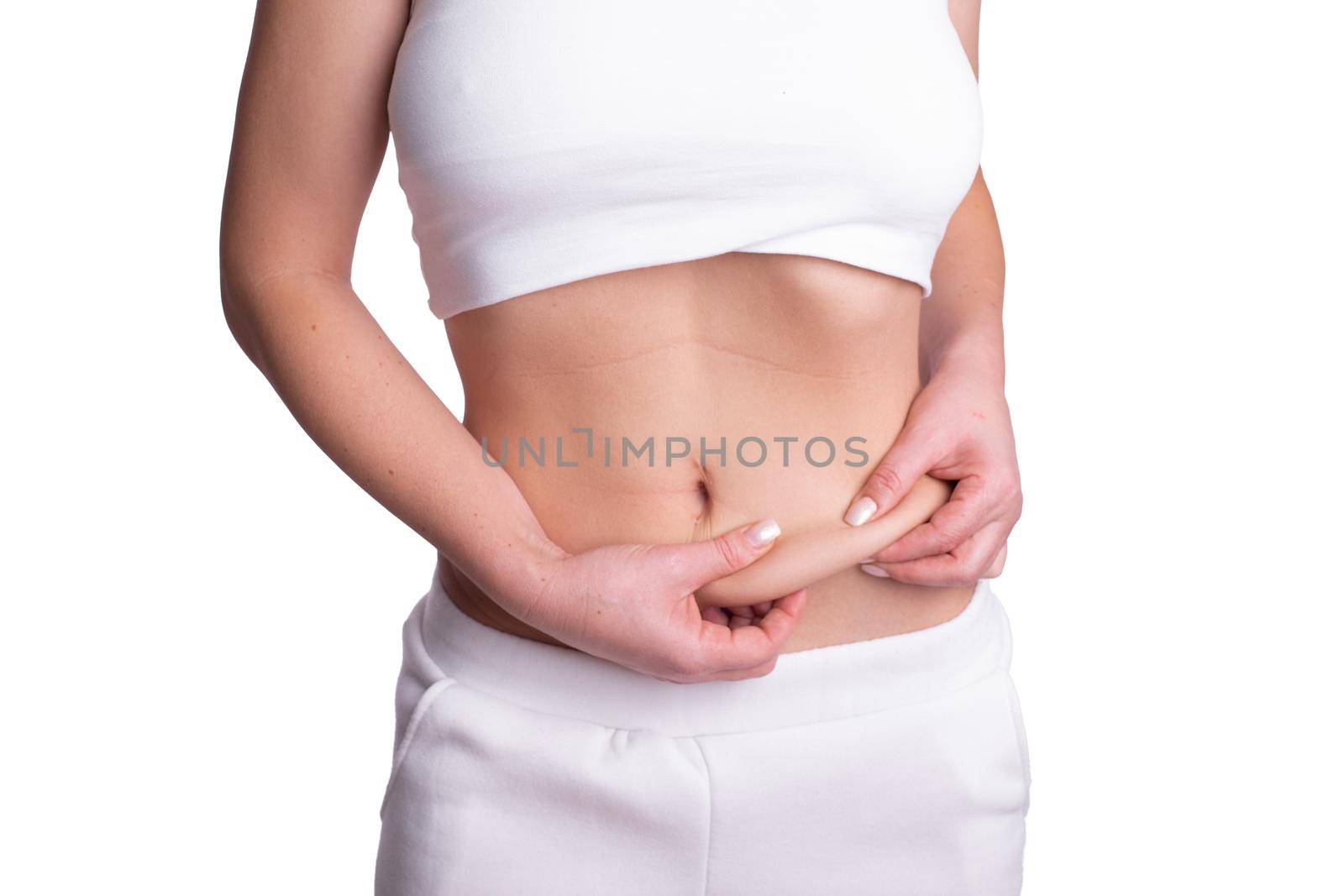 A woman using pinch test as one of the methods for measuring body fat by adamr