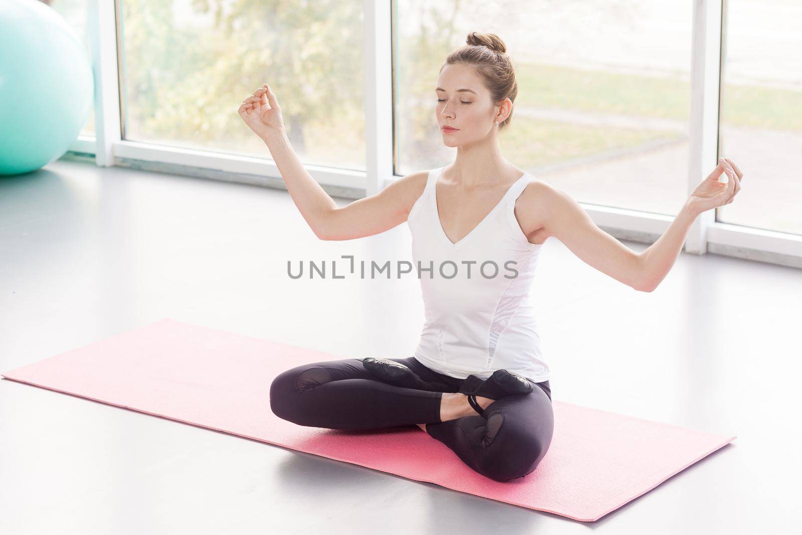 Bound Angle. Baddha Koṇāsana, lotus posture. Beautiful woman doing yoga by Khosro1