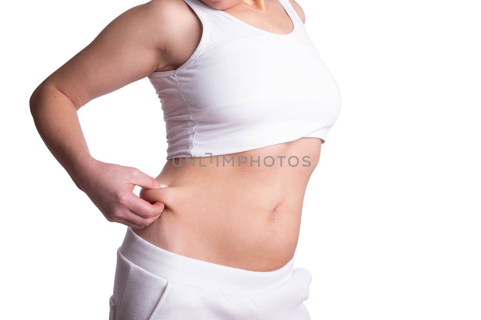 A woman using pinch test as one of the methods for measuring body fat on belly