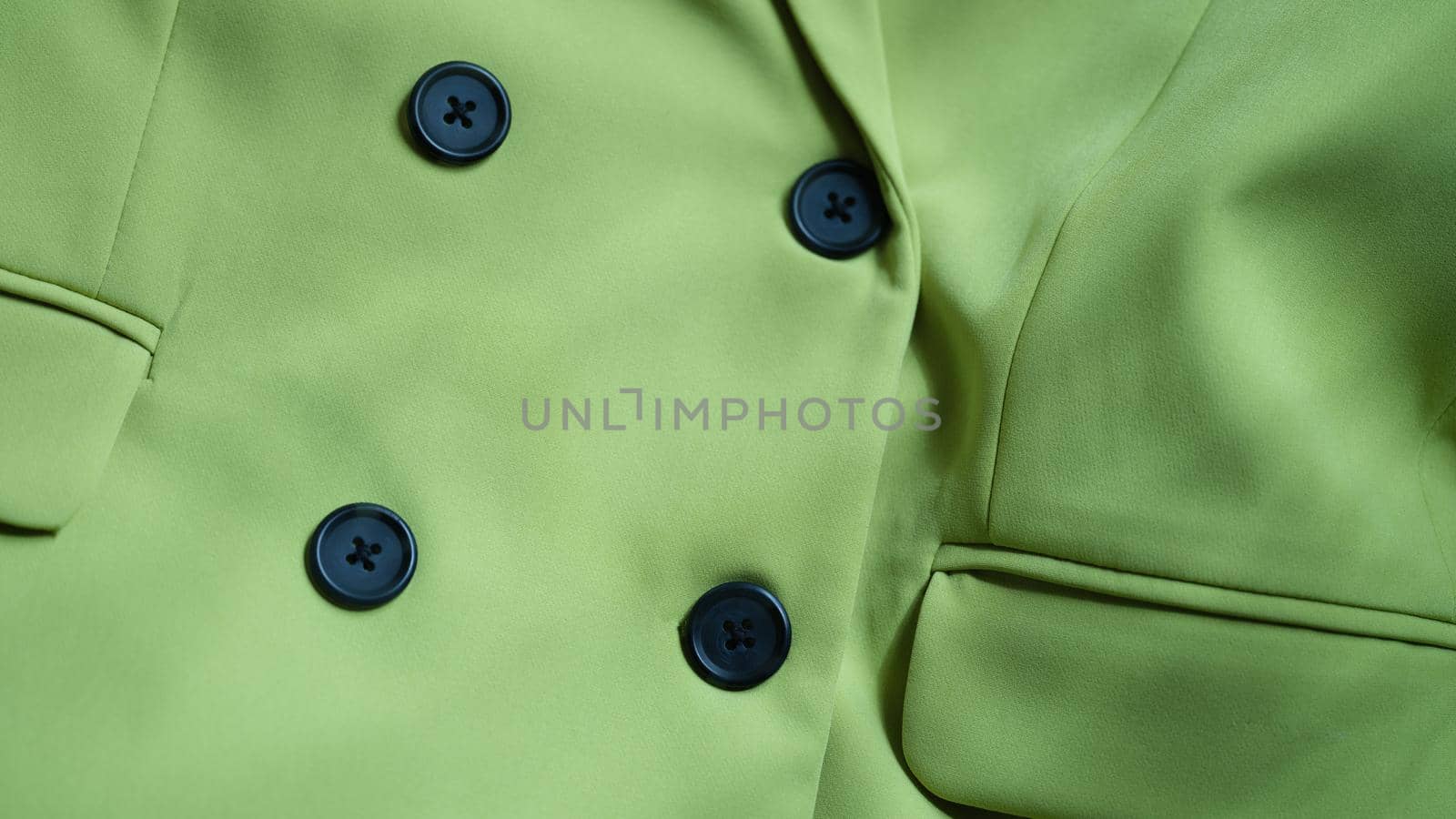 Light green jacket blouse with black buttons. Stylish trendy color in clothes concept