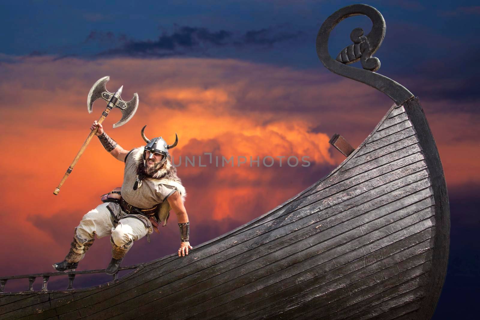 Strong angry bearded Viking with axe jumping from his ship to attack and war.