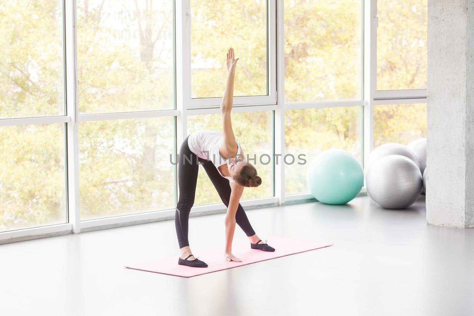 Mill, pilates exercise. Woman doing fitness. Studio shot