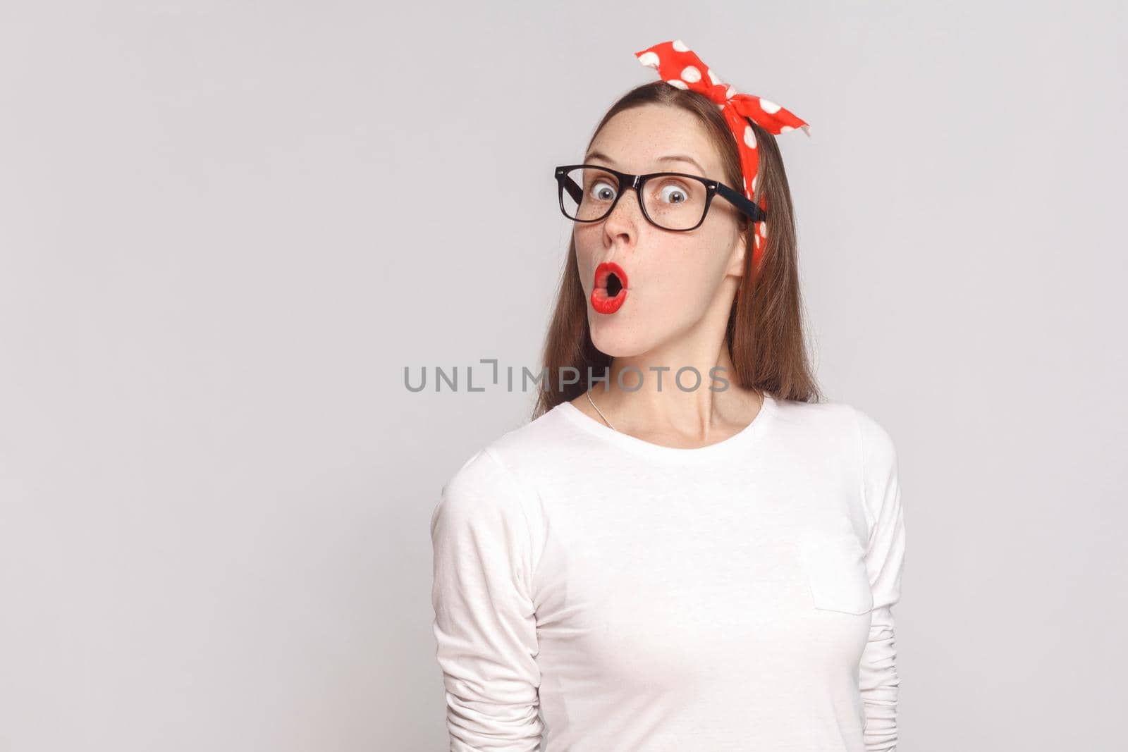 woman in white t-shirt with freckles, black glasses, red lips and head band. by Khosro1