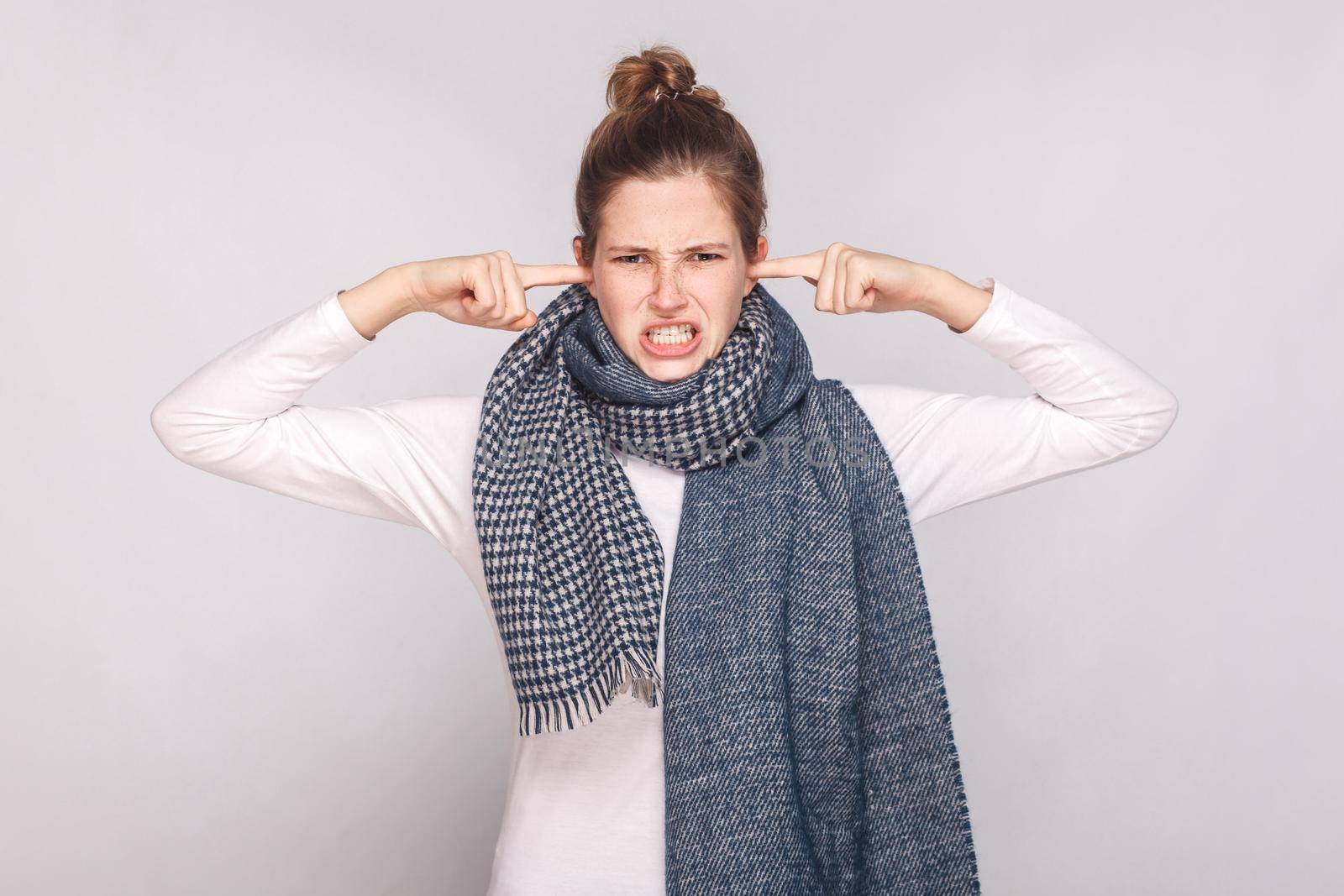 Not hear you! Sick young woman touching fingers her ears. Studio shot