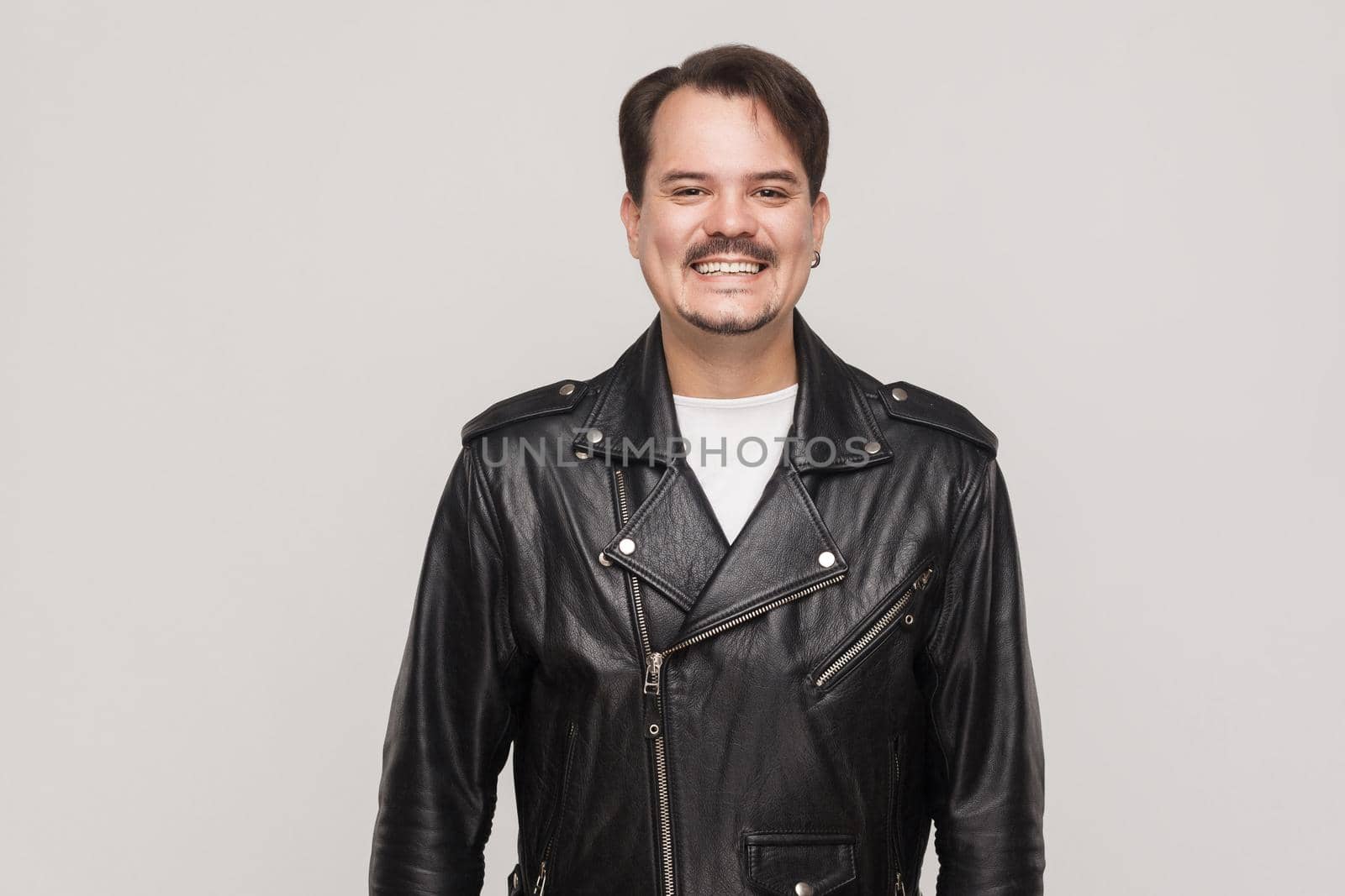 Happiness adult man in leather jacket, looking at camera and toothy smile. by Khosro1