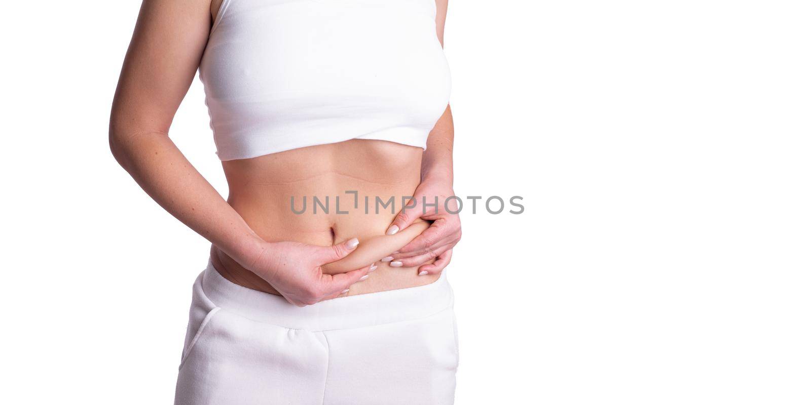 A woman using pinch test as one of the methods for measuring body fat on belly