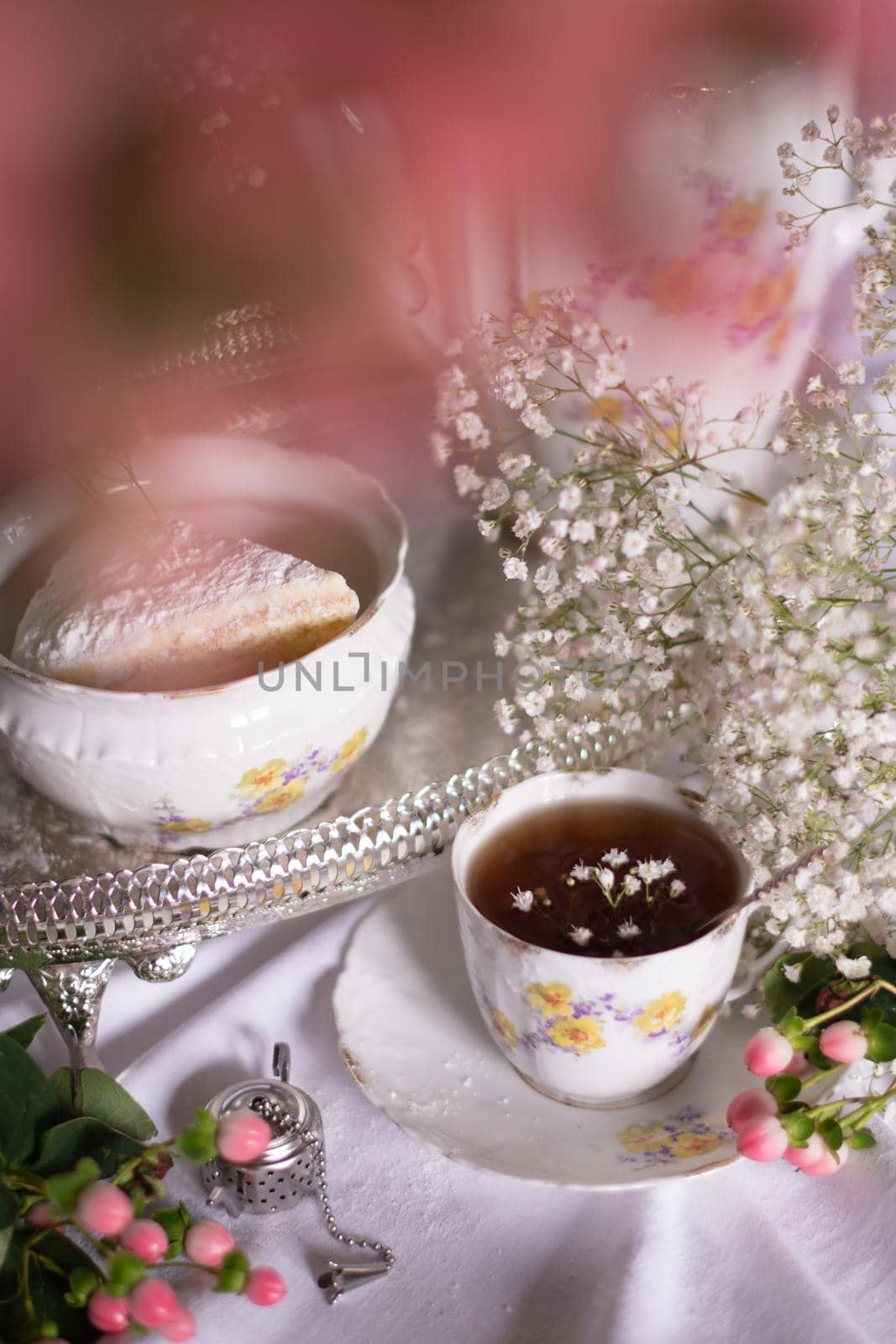 white still life with cheesecake gypsophila and cup of tea, light and airy, High quality photo,table setting for tea drinking in the English style