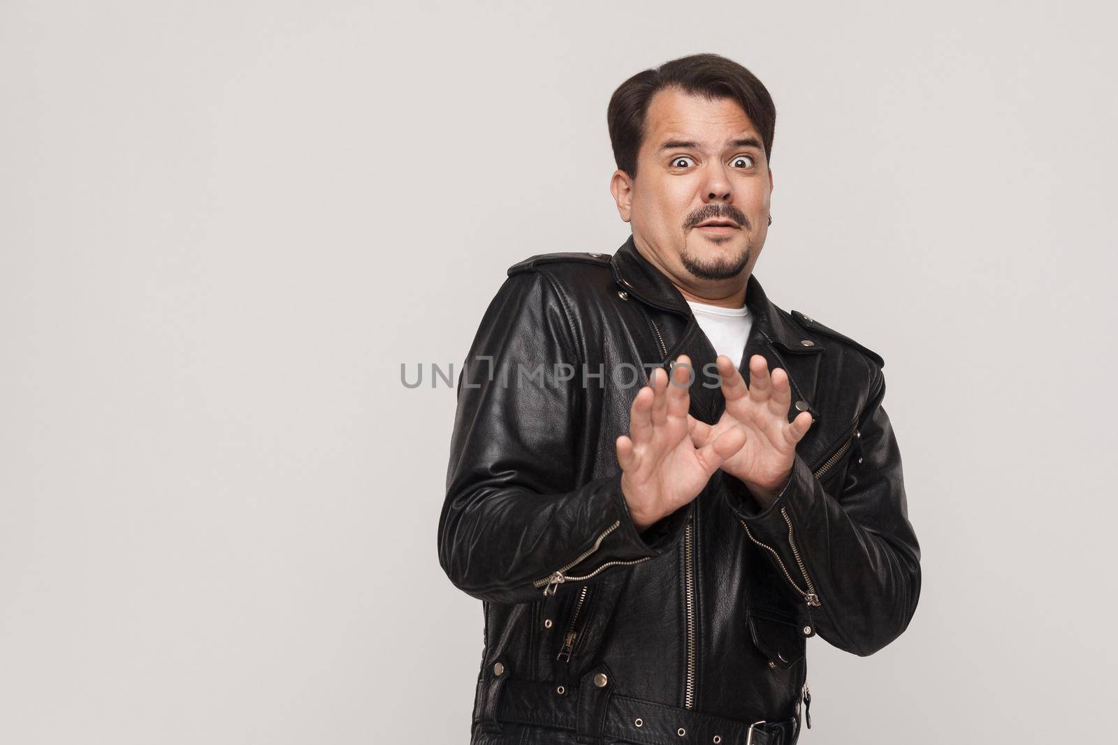 Scary, fear concept. Man with big eyes looking at camera with shocked face. Studio shot