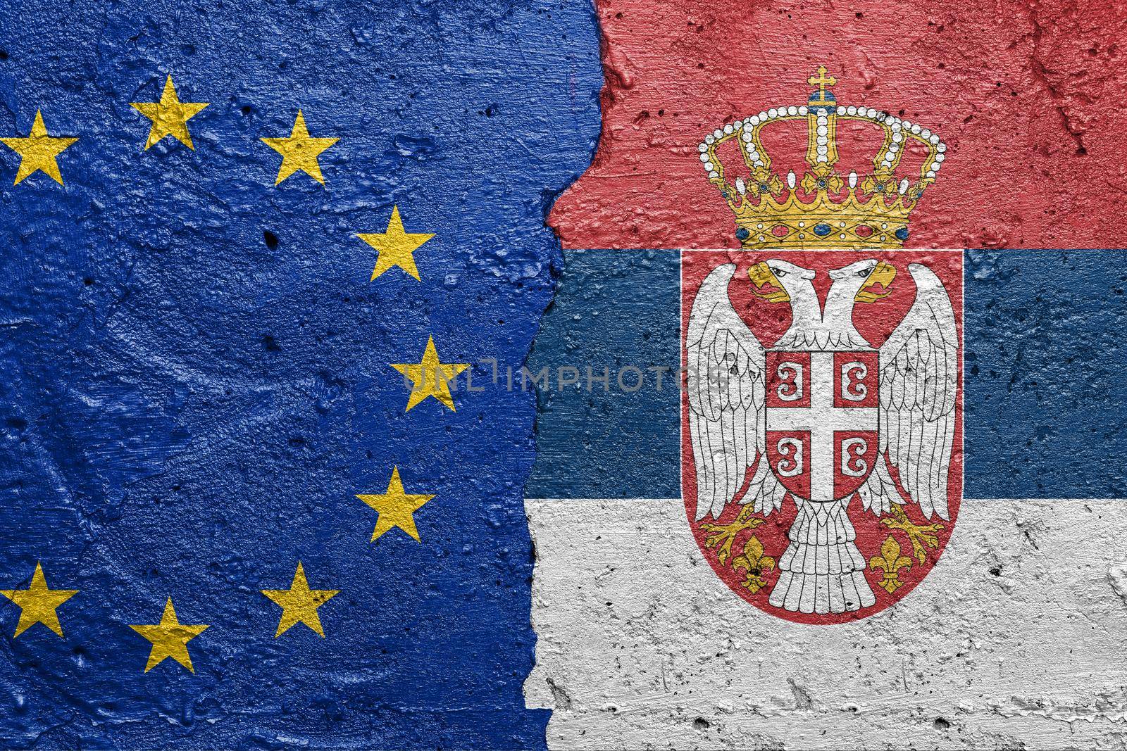 European Union and Serbia flags  - Cracked concrete wall painted with a EU flag on the left and a Serbian flag on the right