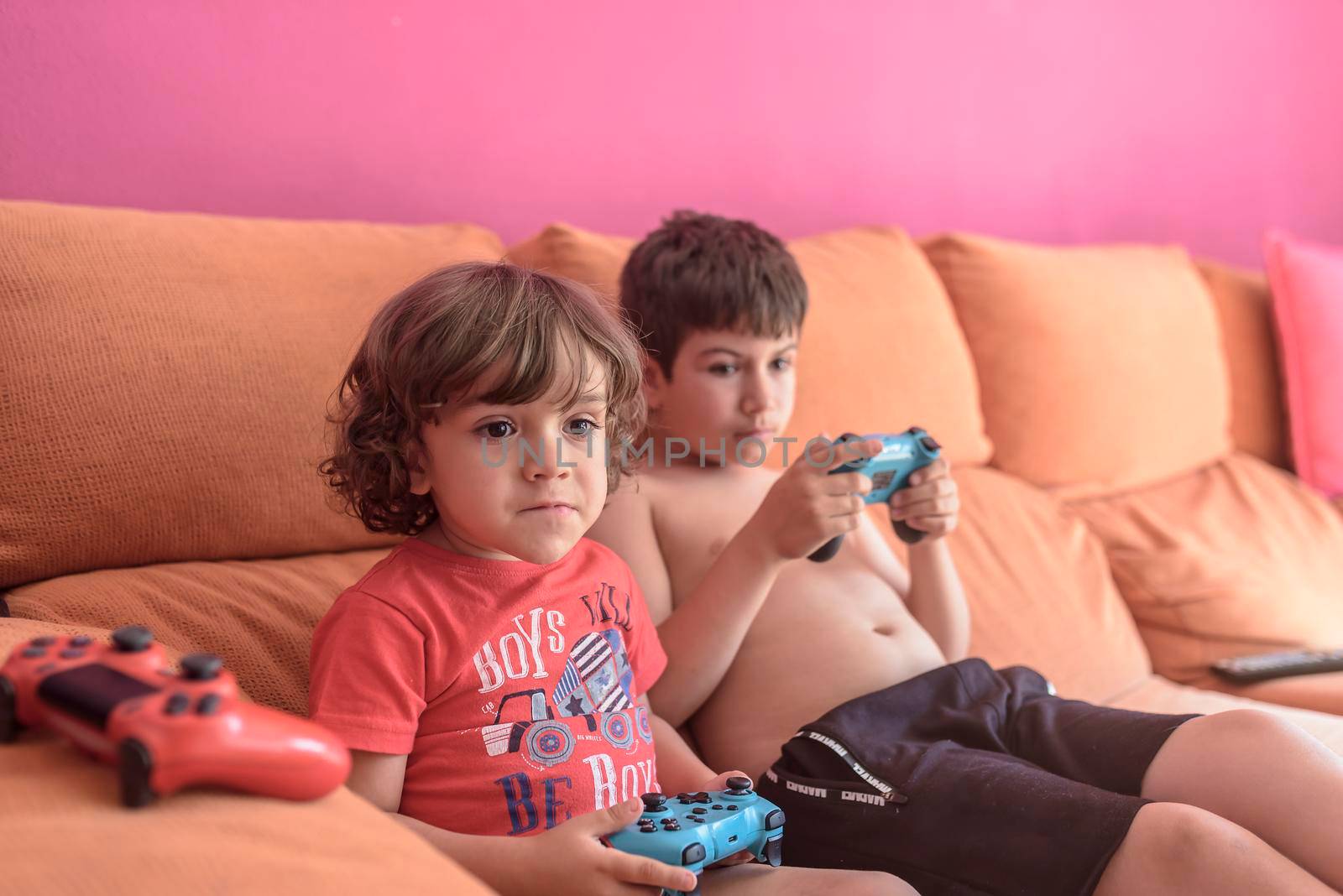 two little boys having lots of fun with video games