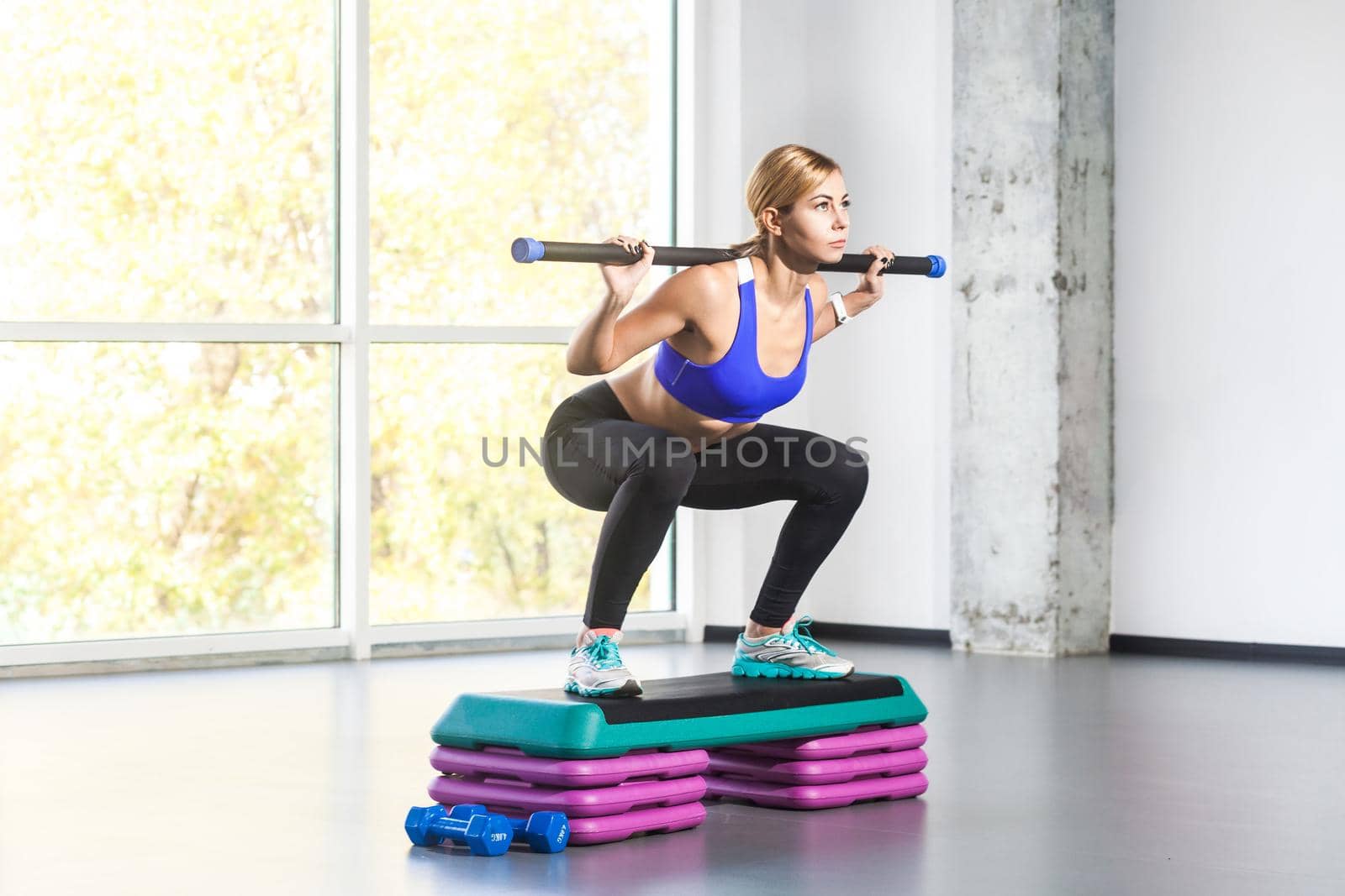 Blonde woman sit-ups, squad on step platform with barbell by Khosro1