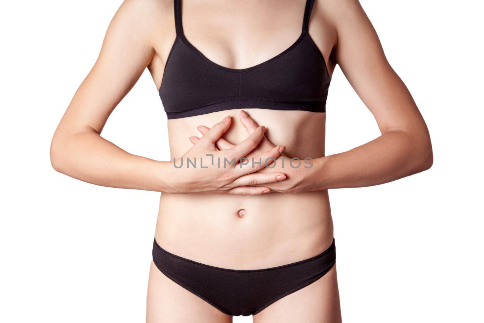 Closeup view of a young woman with stomach pain or digestion or period cycle on white background.