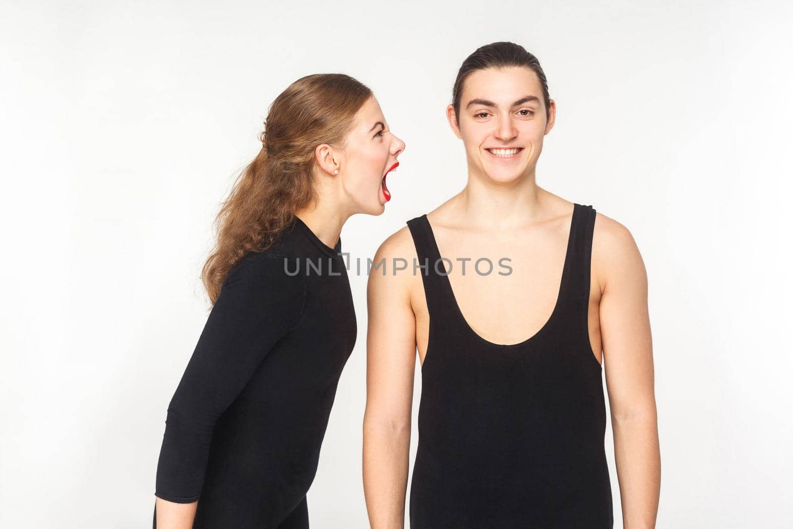 Woman shout at man. Man all the same and does not pay attention. Studio shot, isolated on white background