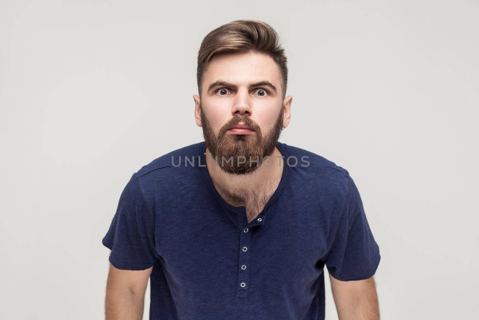 Oh no! Man looking at camera with shocked face. Studio shot, isolated on gray background