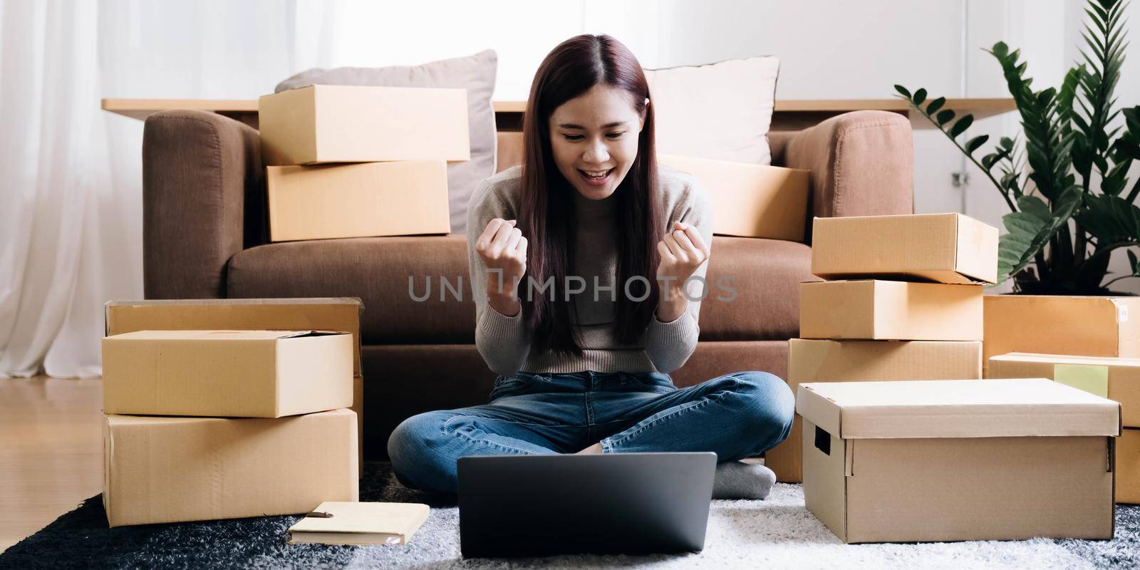 Portrait of Starting small businesses SME owners female entrepreneurs working on receipt box and check online orders to prepare to pack the boxes, sell to customers, SME business ideas online. by wichayada