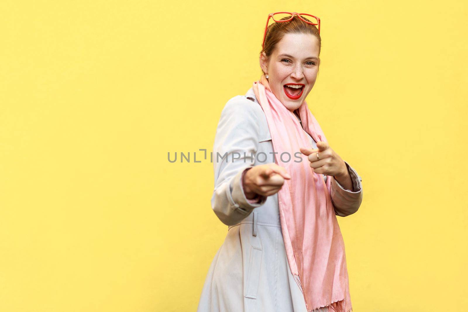 Happy cheerful girl looking and pointing fingers at camera . by Khosro1