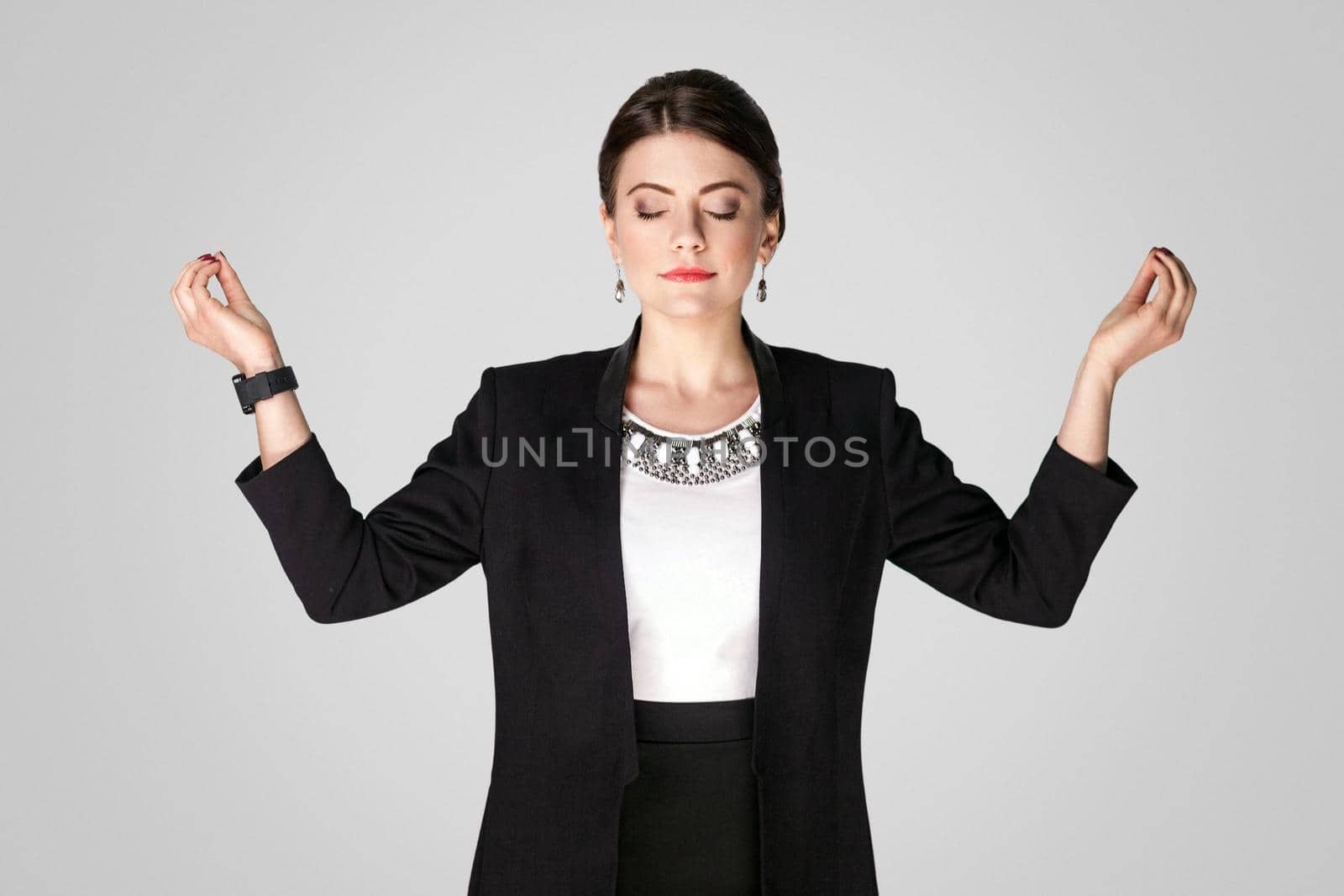 Zen, yoga. Woman closed eyes and have a harmony. Studio shot, indoor. Isolated on grey background