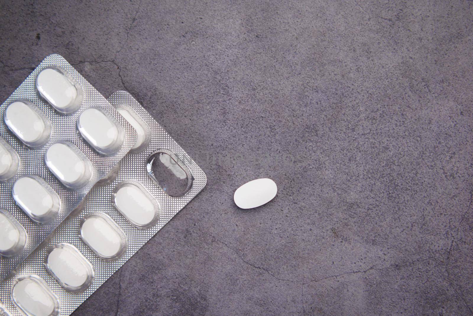 Close up of pills of blister pack on table .