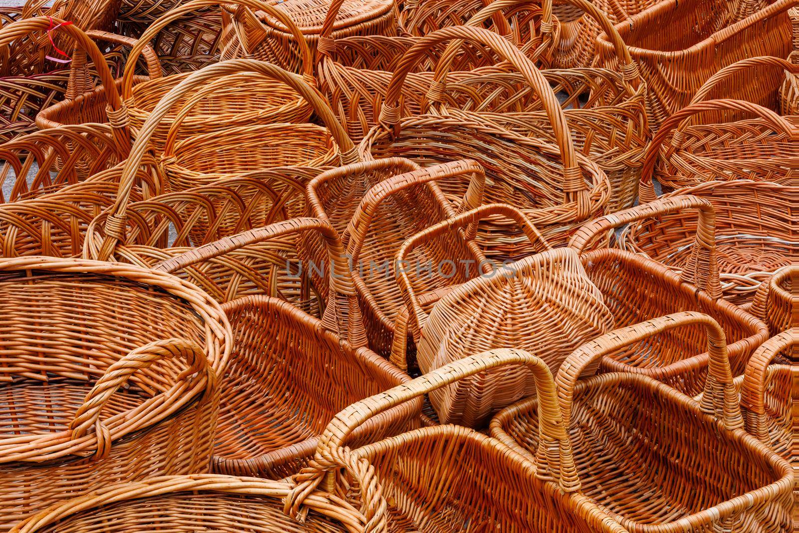 A lot of of many wicker baskets for sale - closeup full-frame background.