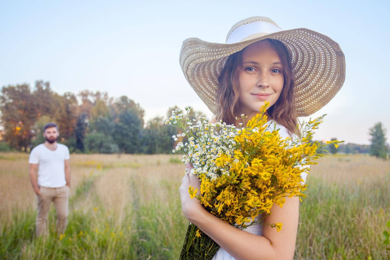 Beautiful woman holding bouquet of yellow flowers and looking by Khosro1