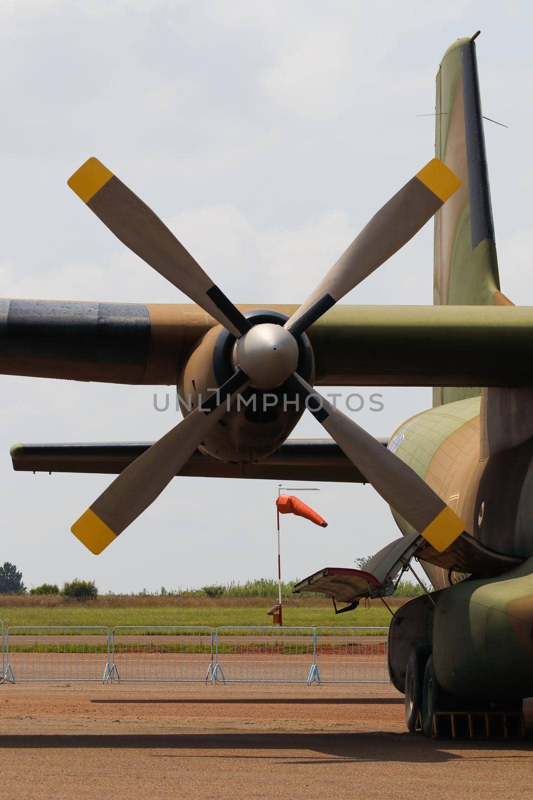 Military transport aircraft propeller engine close-up with airport wind sock, South Africa