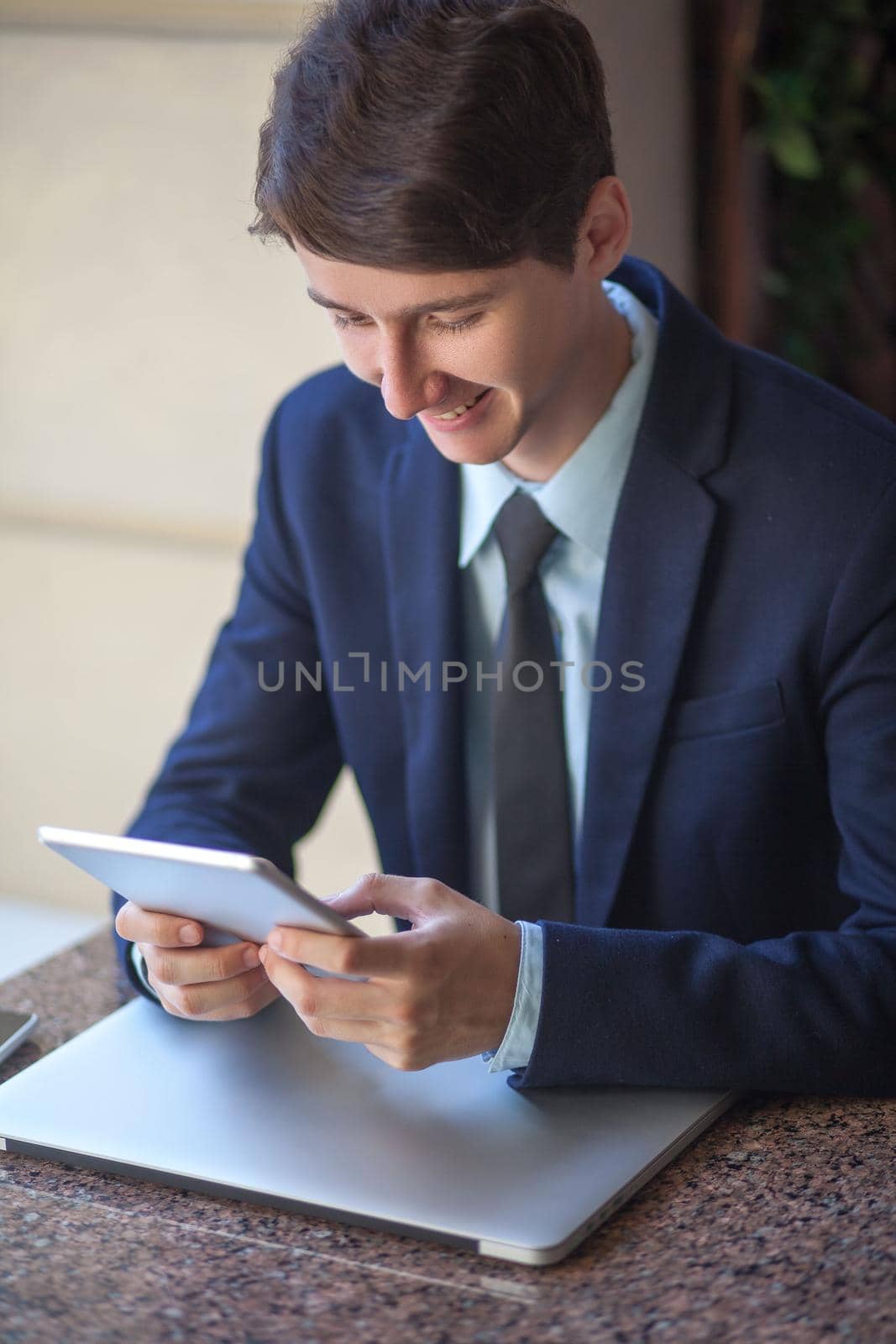 young man in business suit sitting in office by Khosro1