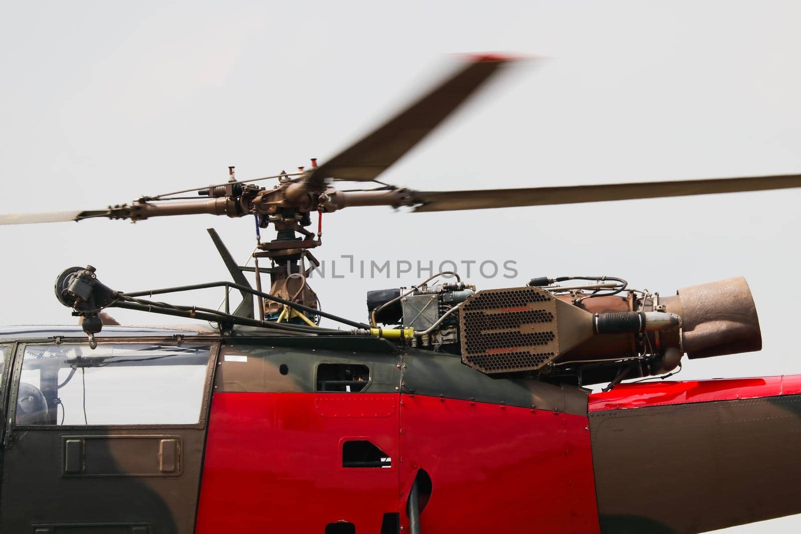 Light military utility helicopter engine with cable hoist and spinning rotor close-up, South Africa