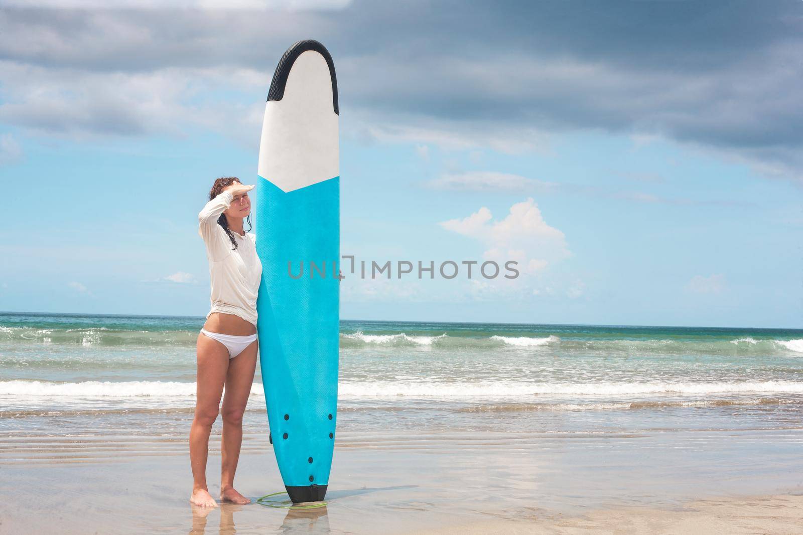 Girl on the waves in the ocean with her Surfboard. Stock image